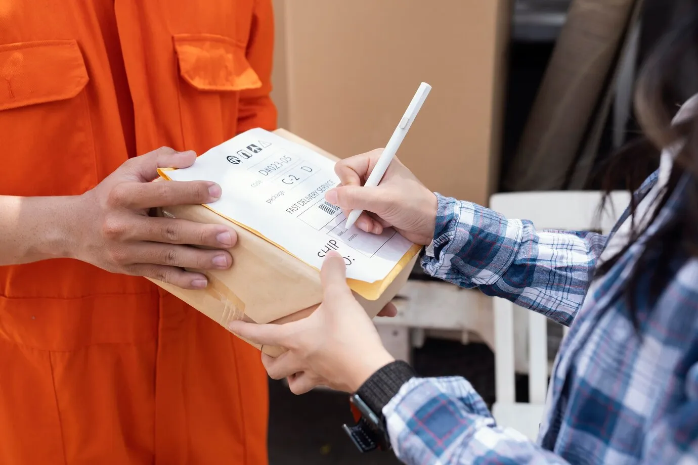 close-up-person-signing-parcel-d